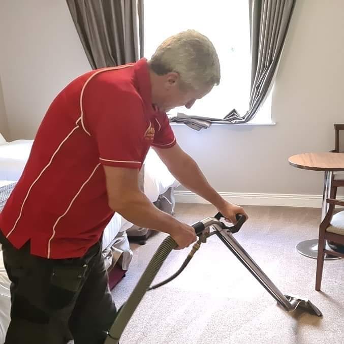 Newbrook Cleaning carrying out carpet cleaning in a furnished room