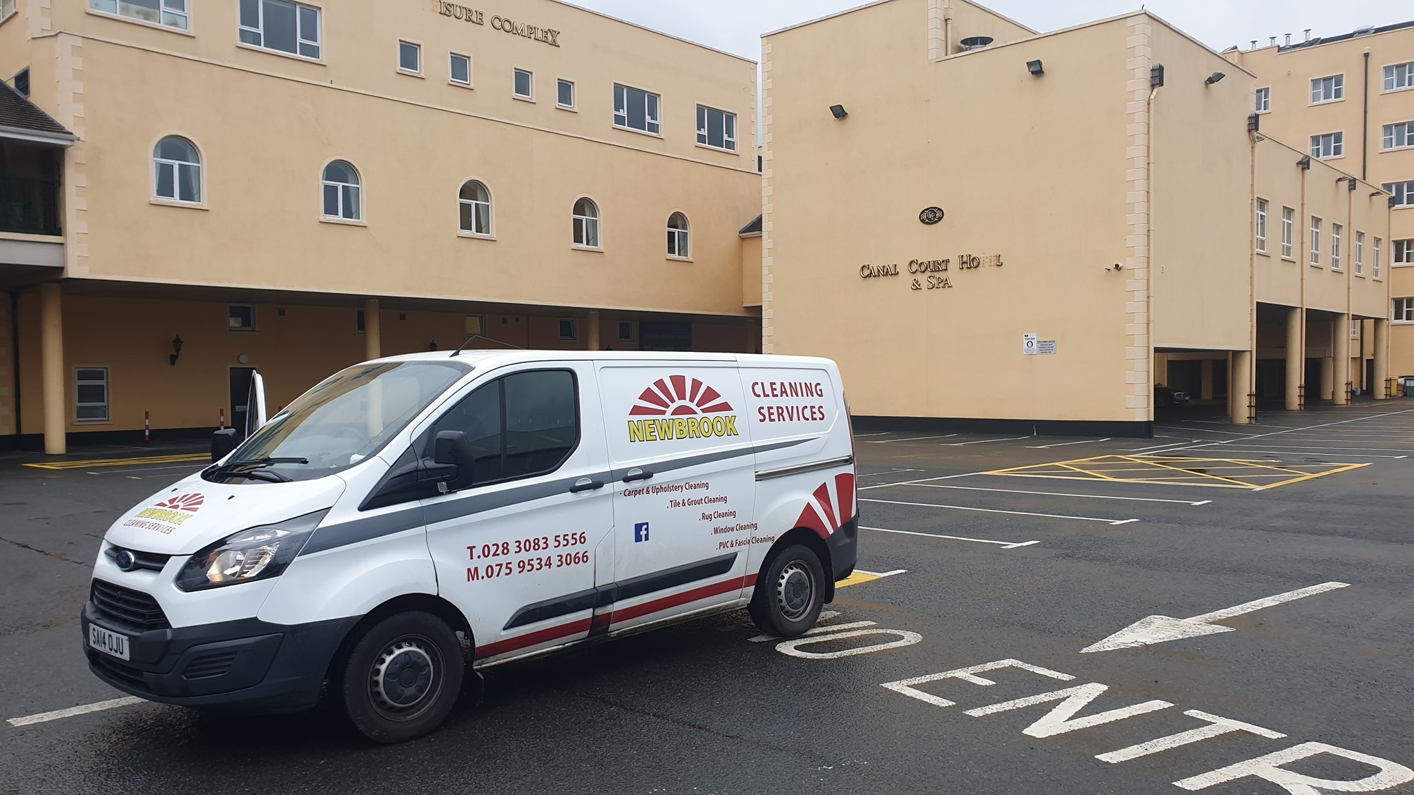 Newbrook Cleaning van on site near a large building